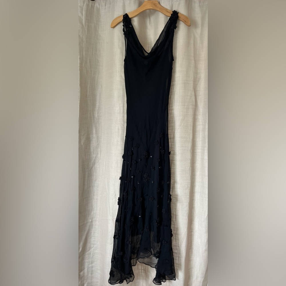 Beautiful elegant dress with embellishments on shoulders and front of dress.
